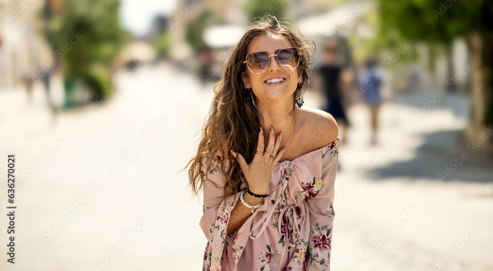 Happy young smiling woman in summer outfit with sunglasses. Outdoor portrait Happy young smiling woman in summer outfit with sunglasses. Outdoor portrait