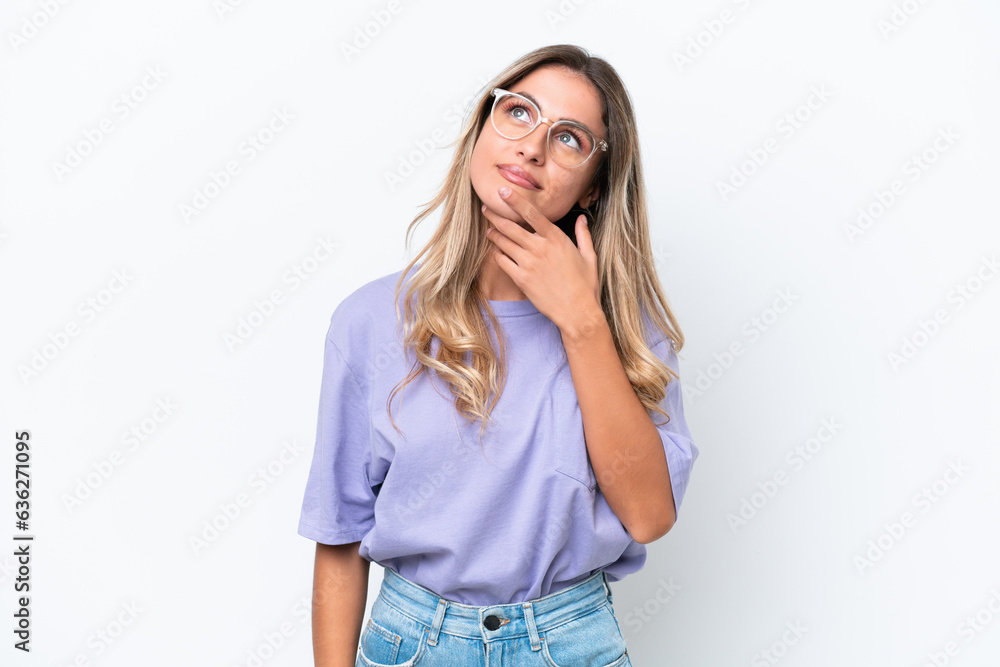 Young Uruguayan woman isolated on white background looking up while smiling Young Uruguayan woman isolated on white background looking up while smiling