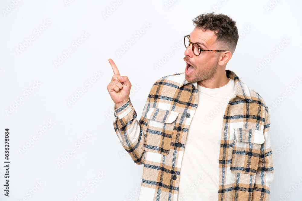 Young caucasian handsome man isolated on white background intending to realizes the solution while lifting a finger up Young caucasian handsome man isolated on white background intending to realizes the solution while lifting a finger up
