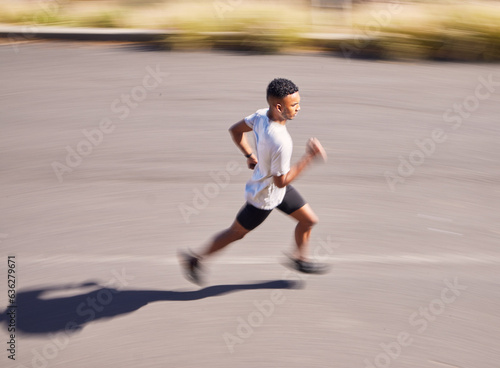 Health, running and motion blur with a sports man on a road for his cardio or endurance workout from above. Exercise, fitness and a runner training for a marathon in the mountains during summer