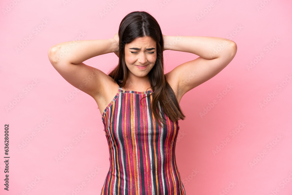 Young Brazilian woman isolated on pink background frustrated and covering ears Young Brazilian woman isolated on pink background frustrated and covering ears