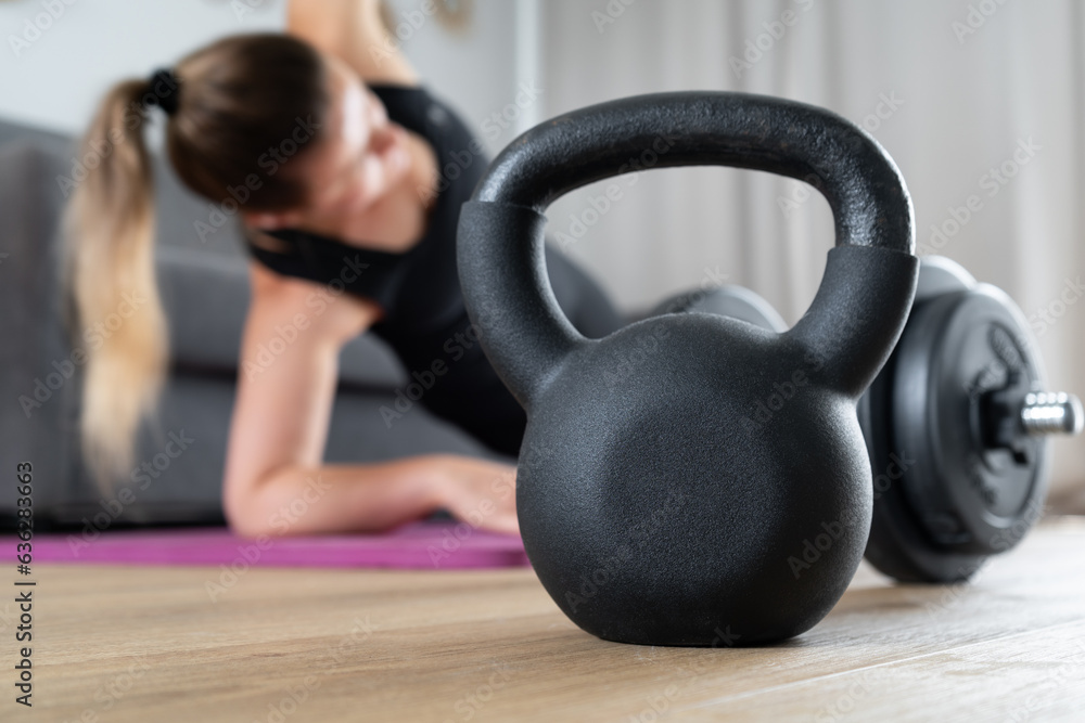 Φωτογραφία Woman exercising at home in the living room on yoga mat