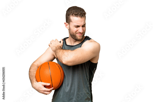 Handsome young man playing basketball over isolated chroma key background suffering from pain in shoulder for having made an effort