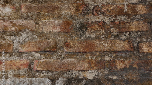 Old brick wall with crumbling and mossy plaster