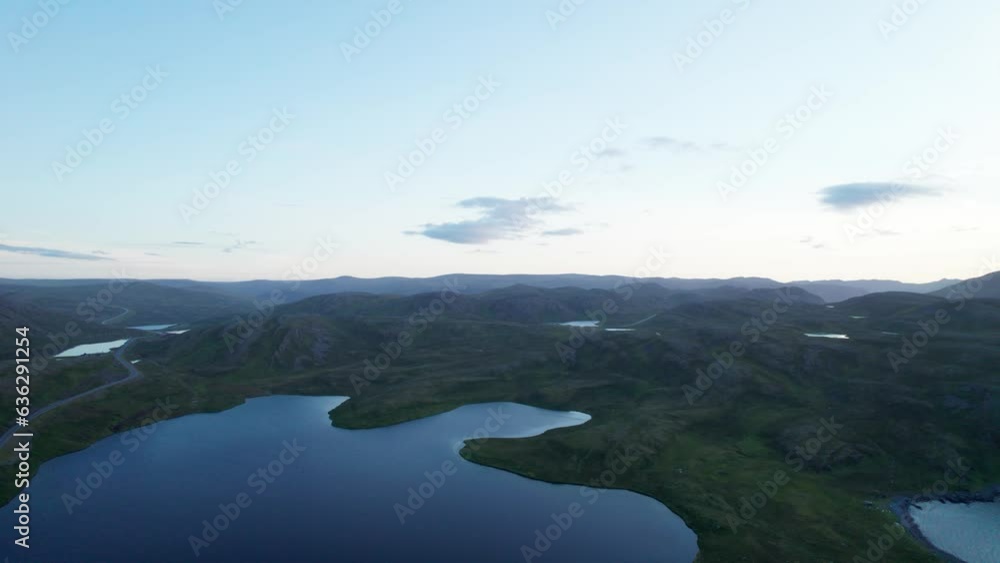 Aerial shot of multiple lake over a mountain with sunset in the background, Skarsvag, Norway Aerial shot of multiple lake over a mountain with sunset in the background, Skarsvag, Norway