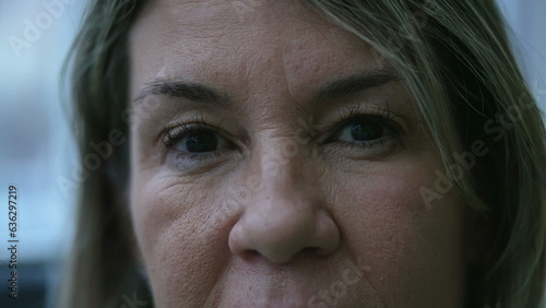 Принти на полотні Mature woman macro close-up eyes staring at camera with serious expression
