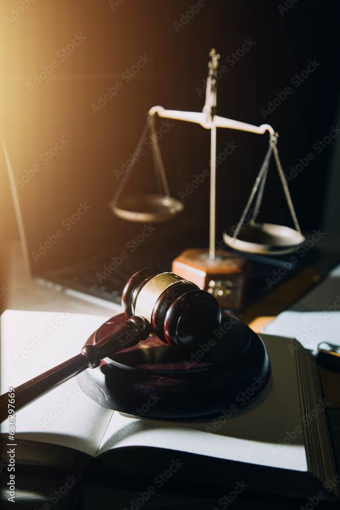 law legal technology concept. judge gavel on computer with scales of justice on desk of lawyer. law legal technology concept. judge gavel on computer with scales of justice on desk of lawyer.