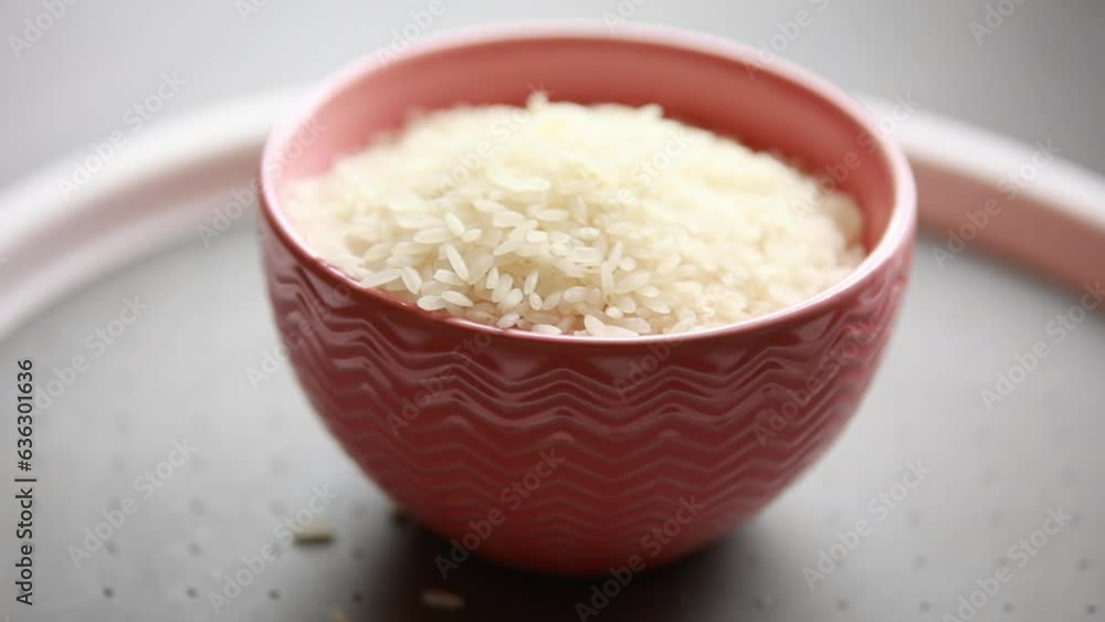 raw white rice in a bowl close up on the kitchen table raw white rice in a bowl close up on the kitchen table