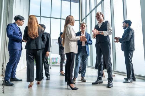 Fotografie Business people talking, discussing  and sharing ideas before a meeting, conference or training at work