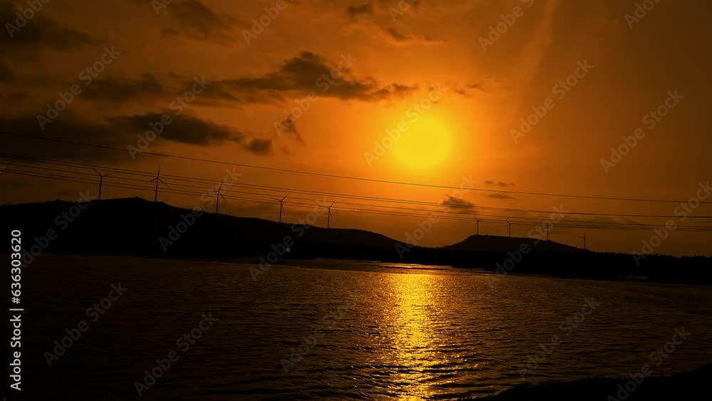 A rare orangish view of a beautiful sunset over the lake, reflected in the waters A rare orangish view of a beautiful sunset over the lake, reflected in the waters