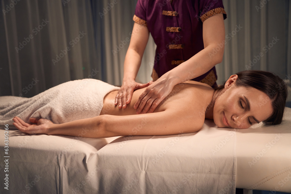 Spa customer sleeping during relaxing classic massage session Spa customer sleeping during relaxing classic massage session