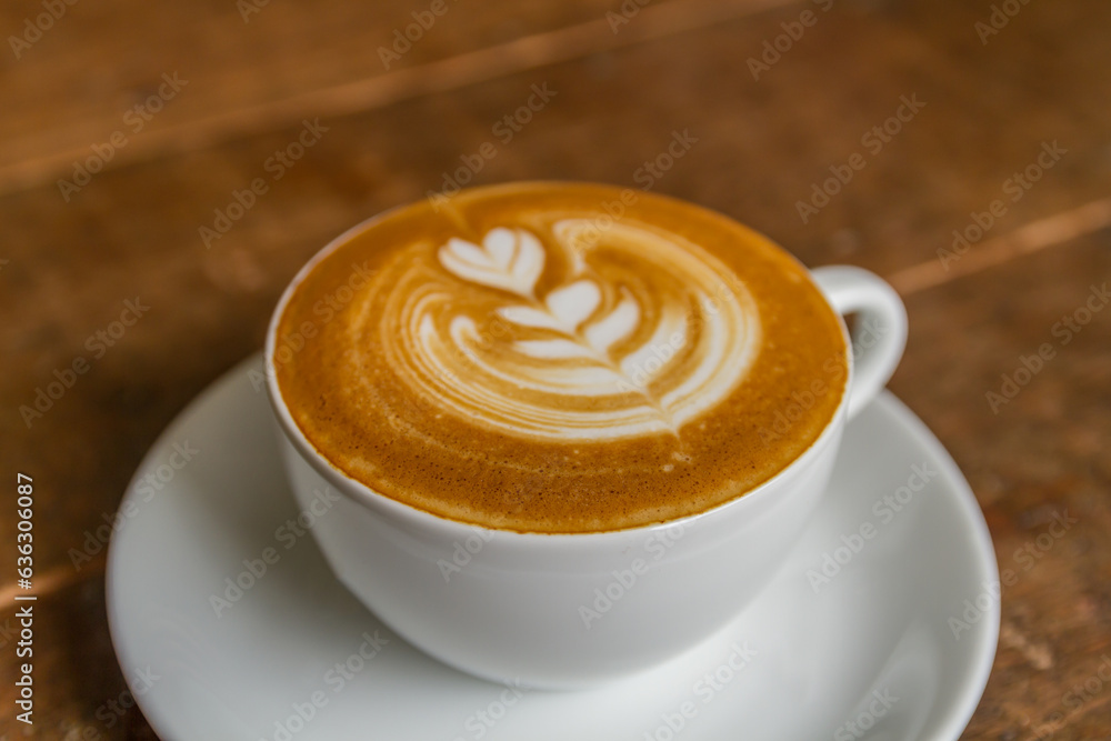 beautiful patterned milk coffee in a white cup beautiful patterned milk coffee in a white cup