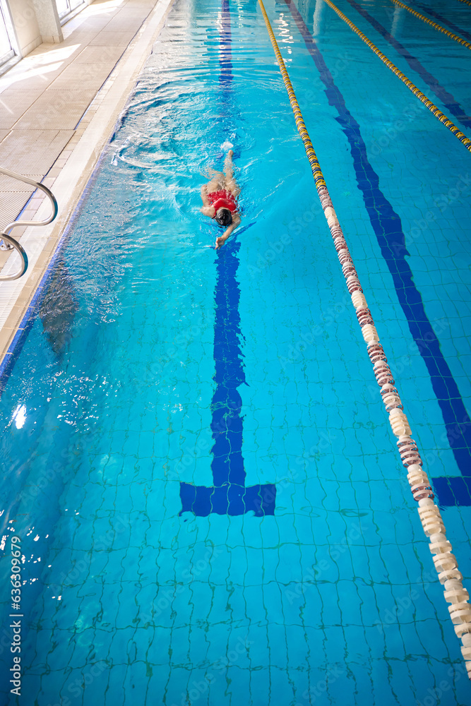 Female swimmer swimming on her back in pool