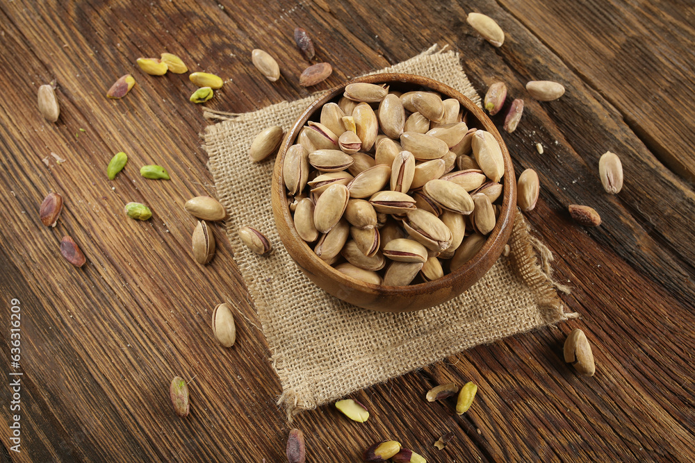 DRİED NUTS AND FRUİTS IN WOODEN BOWL ON BROWN FLOOR DRİED NUTS AND FRUİTS IN WOODEN BOWL ON BROWN FLOOR