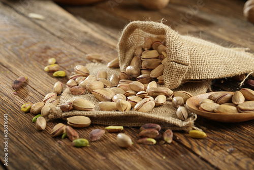 DRİED NUTS AND FRUİTS IN WOODEN BOWL ON BROWN FLOOR