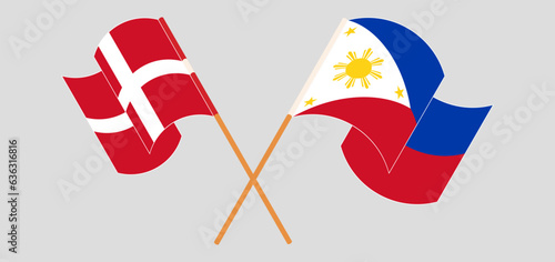Crossed and waving flags of Denmark and the Philippines