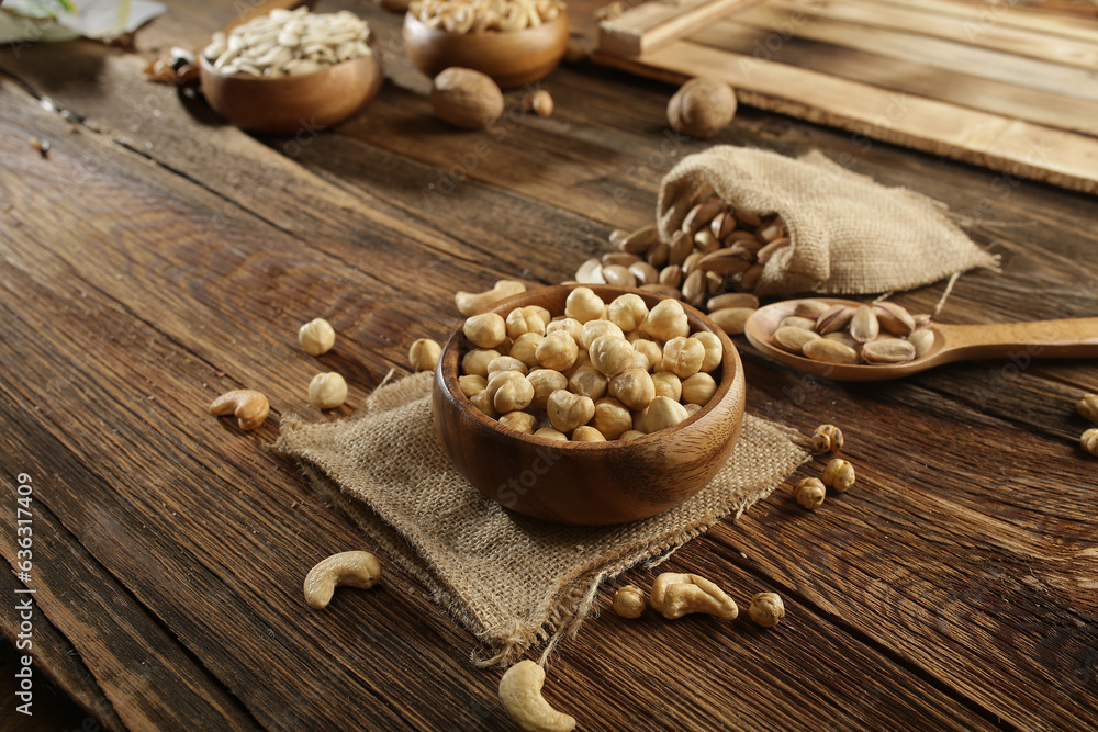 DRİED NUTS AND FRUİTS IN WOODEN BOWL ON BROWN FLOOR DRİED NUTS AND FRUİTS IN WOODEN BOWL ON BROWN FLOOR