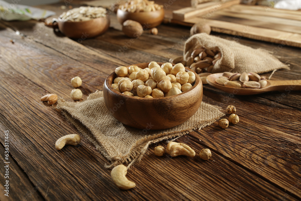 DRİED NUTS AND FRUİTS IN WOODEN BOWL ON BROWN FLOOR DRİED NUTS AND FRUİTS IN WOODEN BOWL ON BROWN FLOOR