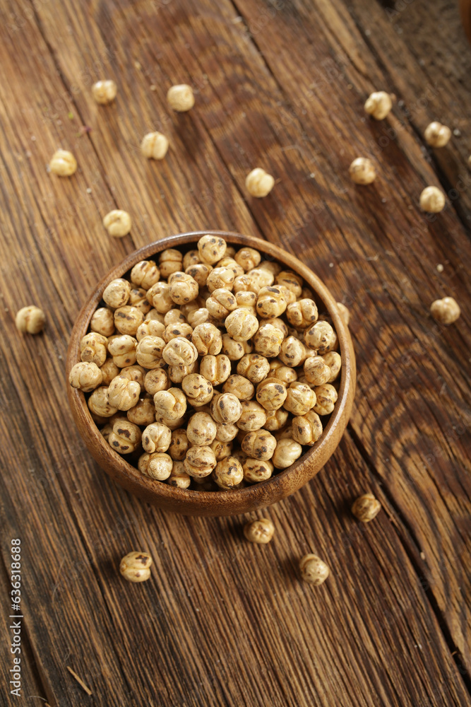 DRİED NUTS AND FRUİTS IN WOODEN BOWL ON BROWN FLOOR DRİED NUTS AND FRUİTS IN WOODEN BOWL ON BROWN FLOOR