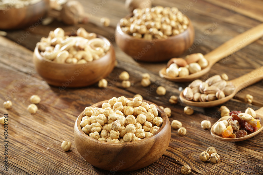 DRİED NUTS AND FRUİTS IN WOODEN BOWL ON BROWN FLOOR DRİED NUTS AND FRUİTS IN WOODEN BOWL ON BROWN FLOOR