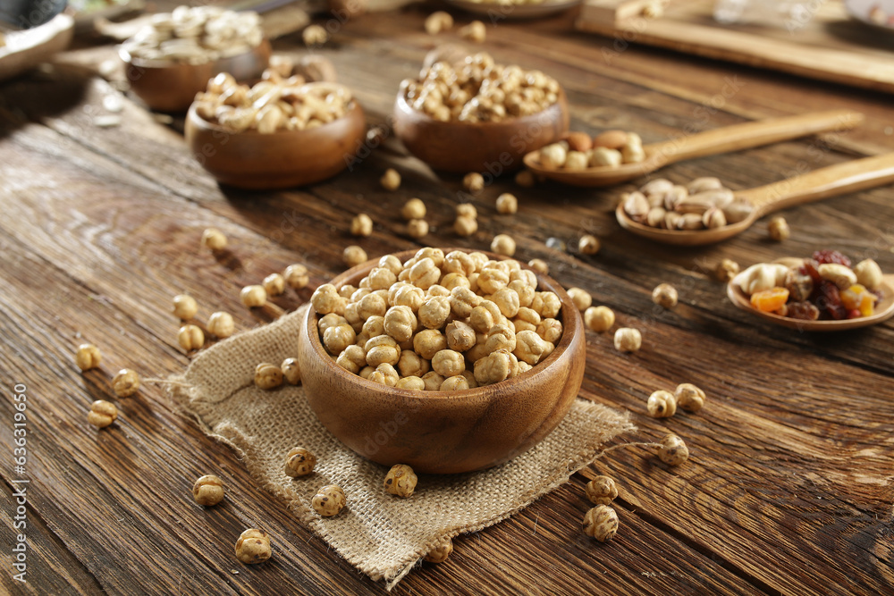 DRİED NUTS AND FRUİTS IN WOODEN BOWL ON BROWN FLOOR DRİED NUTS AND FRUİTS IN WOODEN BOWL ON BROWN FLOOR