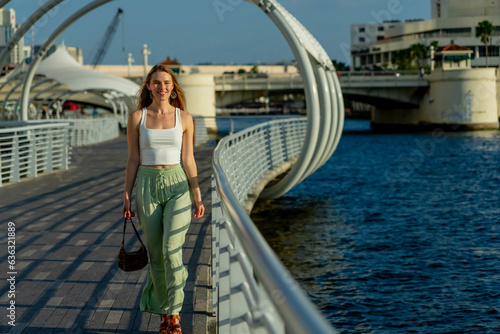 A Lovely Blonde Model Enjoys The Summer Weather In An Urban Environment