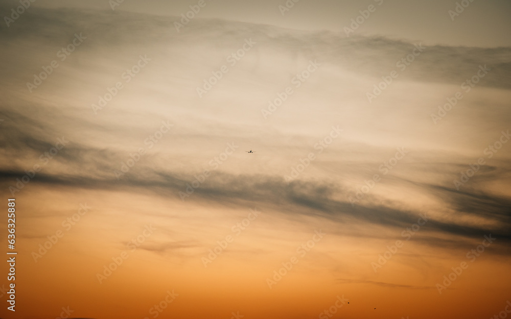 airplane at sunset in the clouds