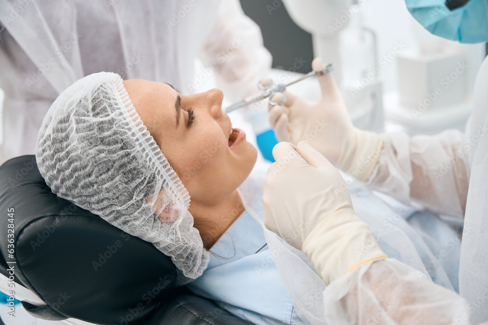 Woman in the dental office receives an injection of painkiller Woman in the dental office receives an injection of painkiller