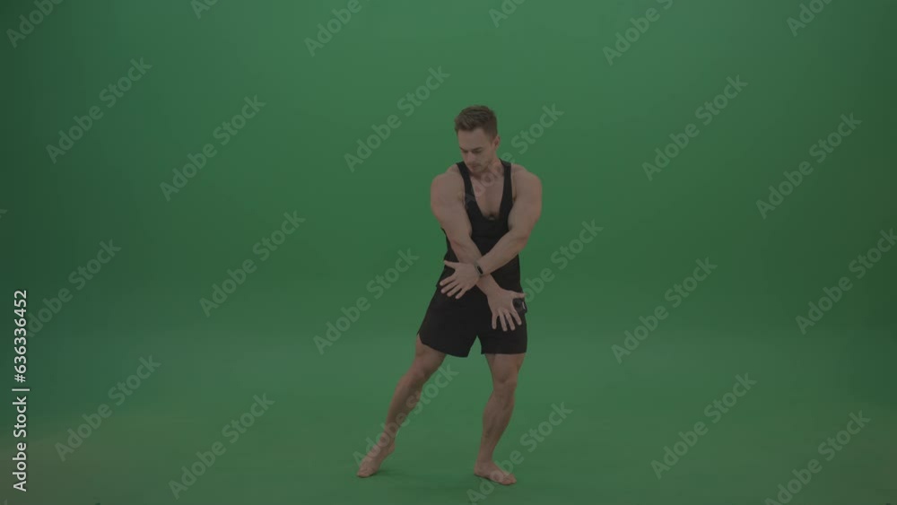 On the green screen background, a fitness trainer specializing in bodybuilding showcases their muscles and biceps On the green screen background, a fitness trainer specializing in bodybuilding showcases their muscles and biceps