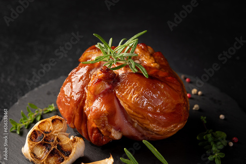 Delicious Smoked pork knuckle in a crispy crust. Tender and juicy pork wrapped in crispy.  Festive table with delicious food on slate boards. Roasted Pork leg, German food, Eisbein. photo
