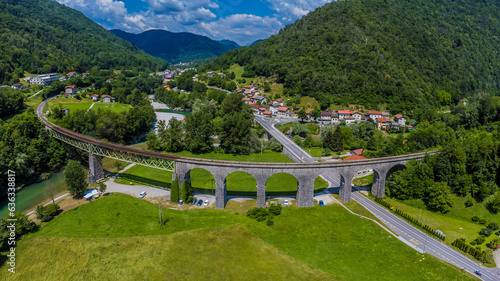 An aerial panorama view above the railway viaduct and town of Bača near Modrej in Slovenia in summertime photo