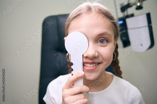 Young female patient in the clinic on ophthalmic diagnostic test