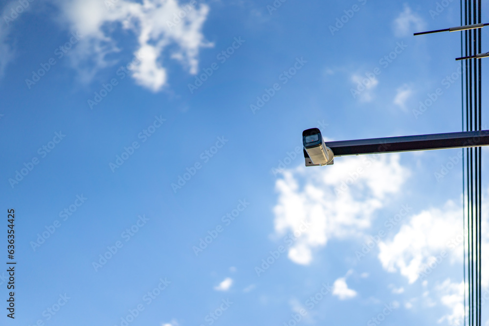 cctv camera is installed on the Metal stick that hung on to electric pole beside the street in village for monitoring and running safety system control in that area. cctv camera is installed on the Metal stick that hung on to electric pole beside the street in village for monitoring and running safety system control in that area.