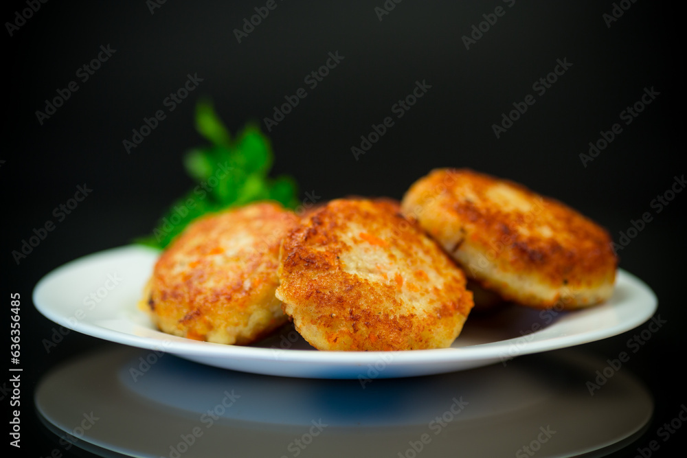 Cooked fried fish cutlets in a plate with herbs. Cooked fried fish cutlets in a plate with herbs.