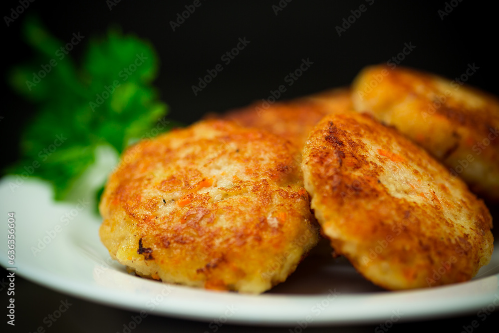 Cooked fried fish cutlets in a plate with herbs. Cooked fried fish cutlets in a plate with herbs.