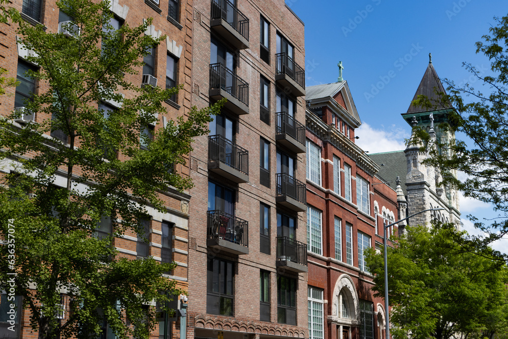 Row of Old Brick Residential and Apartment Buildings in East Harlem of New York City with Green Trees Row of Old Brick Residential and Apartment Buildings in East Harlem of New York City with Green Trees