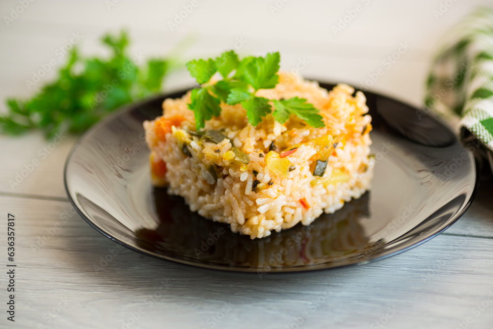 Cooked boiled rice with zucchini, carrots and vegetables in a plate Cooked boiled rice with zucchini, carrots and vegetables in a plate
