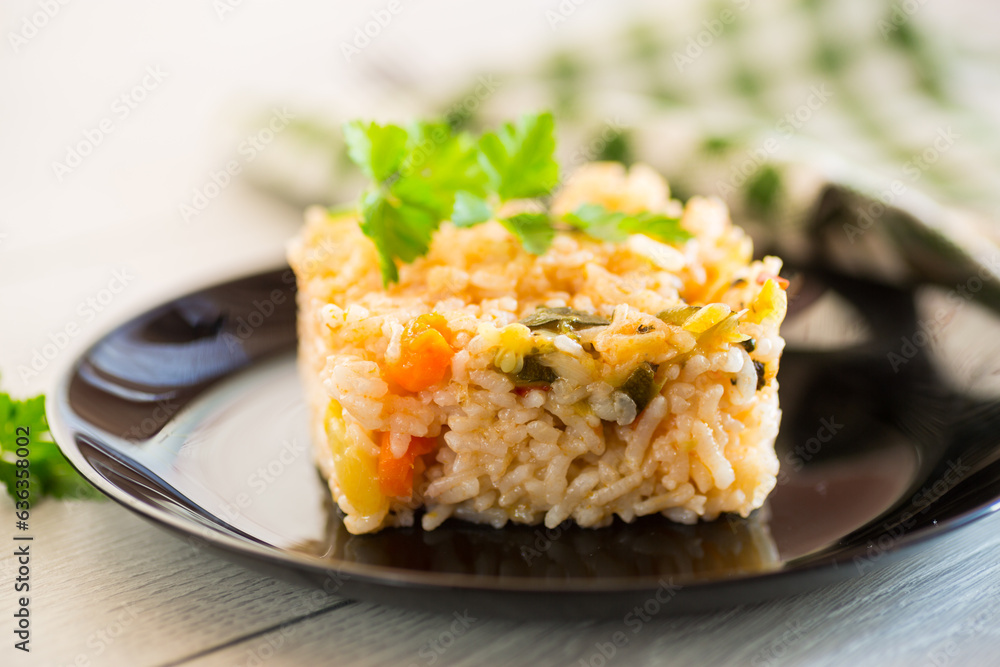 Cooked boiled rice with zucchini, carrots and vegetables in a plate Cooked boiled rice with zucchini, carrots and vegetables in a plate