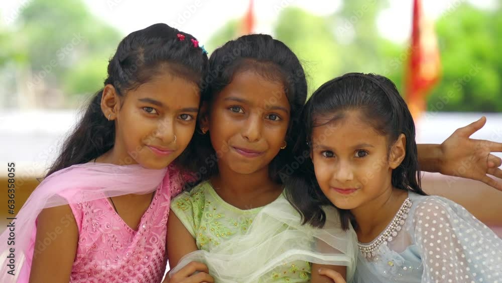 Little kids wearing tradional indian dress enjoying Indian festival. Children in ethnic wear looking at camera