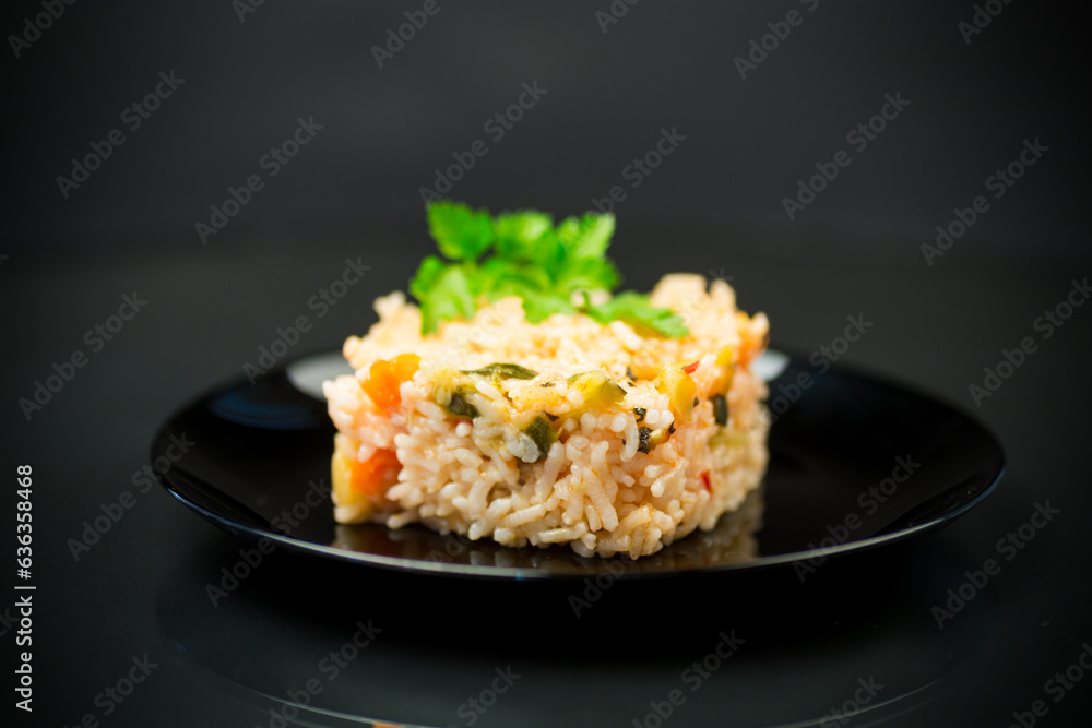 Cooked boiled rice with zucchini, carrots and vegetables in a plate Cooked boiled rice with zucchini, carrots and vegetables in a plate