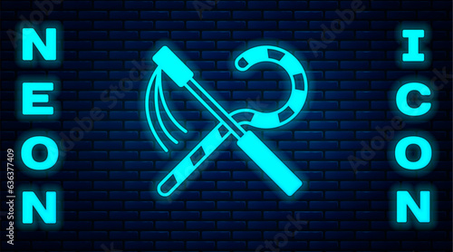Glowing neon Crook and flail icon isolated on brick wall background. Ancient Egypt symbol. Scepters of egypt. Vector