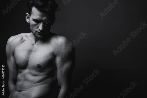 Male beauty concept. Black and white portrait of handsome young man. Perfect hair and skin. Studio shot