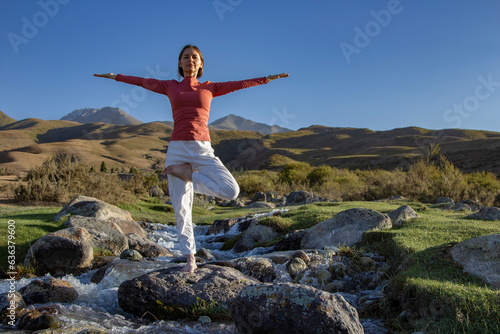 woman yoga and lotus silhouette pose meditation and relax in the mountan river. Healthy and Zen Concept Close up