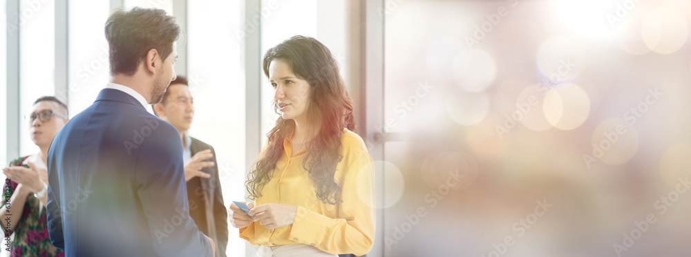 Business man and business woman standing and discussing with corporate colleagues in modern in office. Group of partnership meeting and working together in office. Double exposure and banner cover