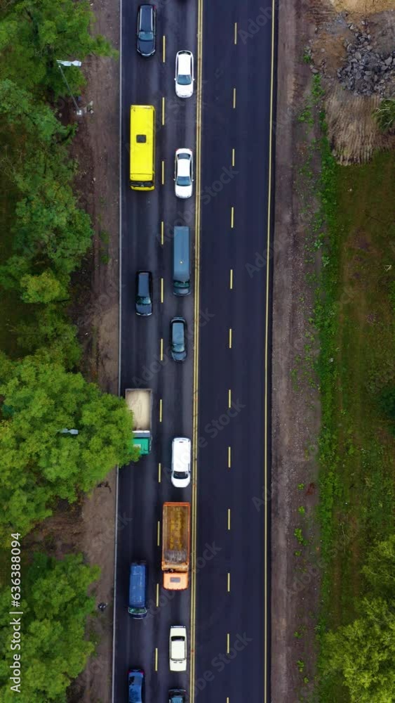 Aerial view of the traffic jam on highway. Cars driving slowly in traffic jam. Aerial vertical, vertical video background. Aerial view of the traffic jam on highway. Cars driving slowly in traffic jam. Aerial vertical, vertical video background.