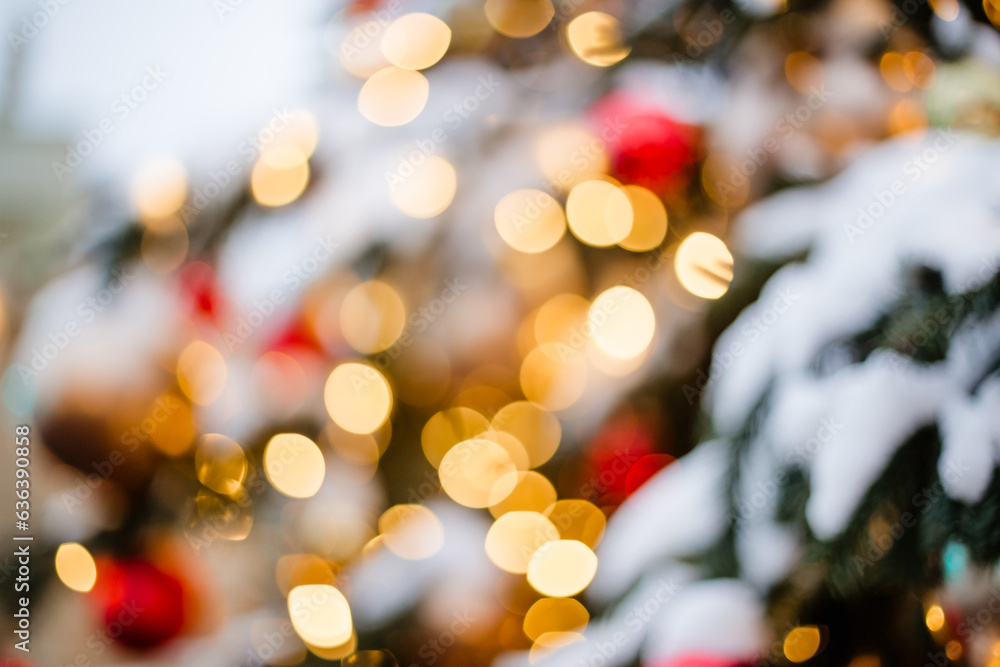 The blurred lights of the garland on the Christmas tree are out of focus. Beautiful festive concept of Christmas holidays and New Year with space for text The blurred lights of the garland on the Christmas tree are out of focus. Beautiful festive concept of Christmas holidays and New Year with space for text