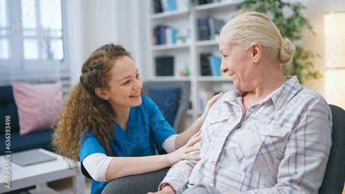 A smiling female social worker visits a senior lady at her home to provide support and care