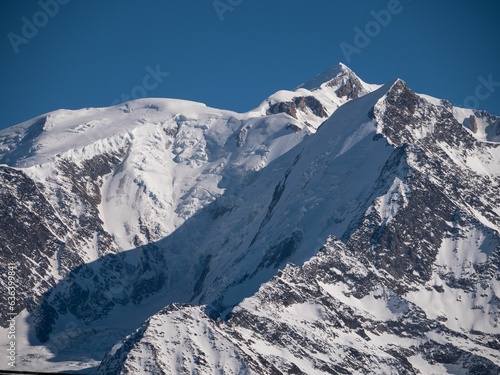 Majestic snow-capped Mont Blanc mountain range  with lush evergreen trees dotting the landscape