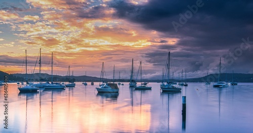 Storm approaching  some moored yachts in a protected bay. © Tim Brand/Wirestock Creators