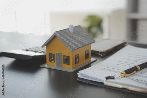 Real estate agent and customer signing contract to buy house, insurance or loan real estate.rent a house,get insurance or loan real estate or property.